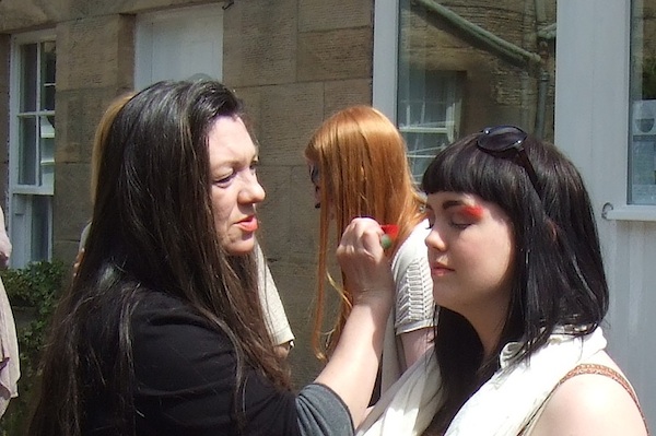 A study in concentration and serenity - painting the faces of the leaflet posse.