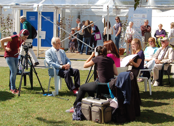 Nicolas Parsons being interviewed in the sunshine.